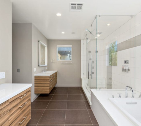 Integral Design Interiors - New Hope, PA. Contemporary bathroom with wall hung vanities and white tile shower and tub