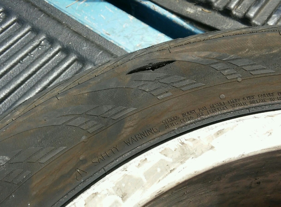 Po-Boys Used Tires 2 - Knoxville, TN. The tire he sold me which blew out while driving with kids in car.  The other tire has a huge knot.